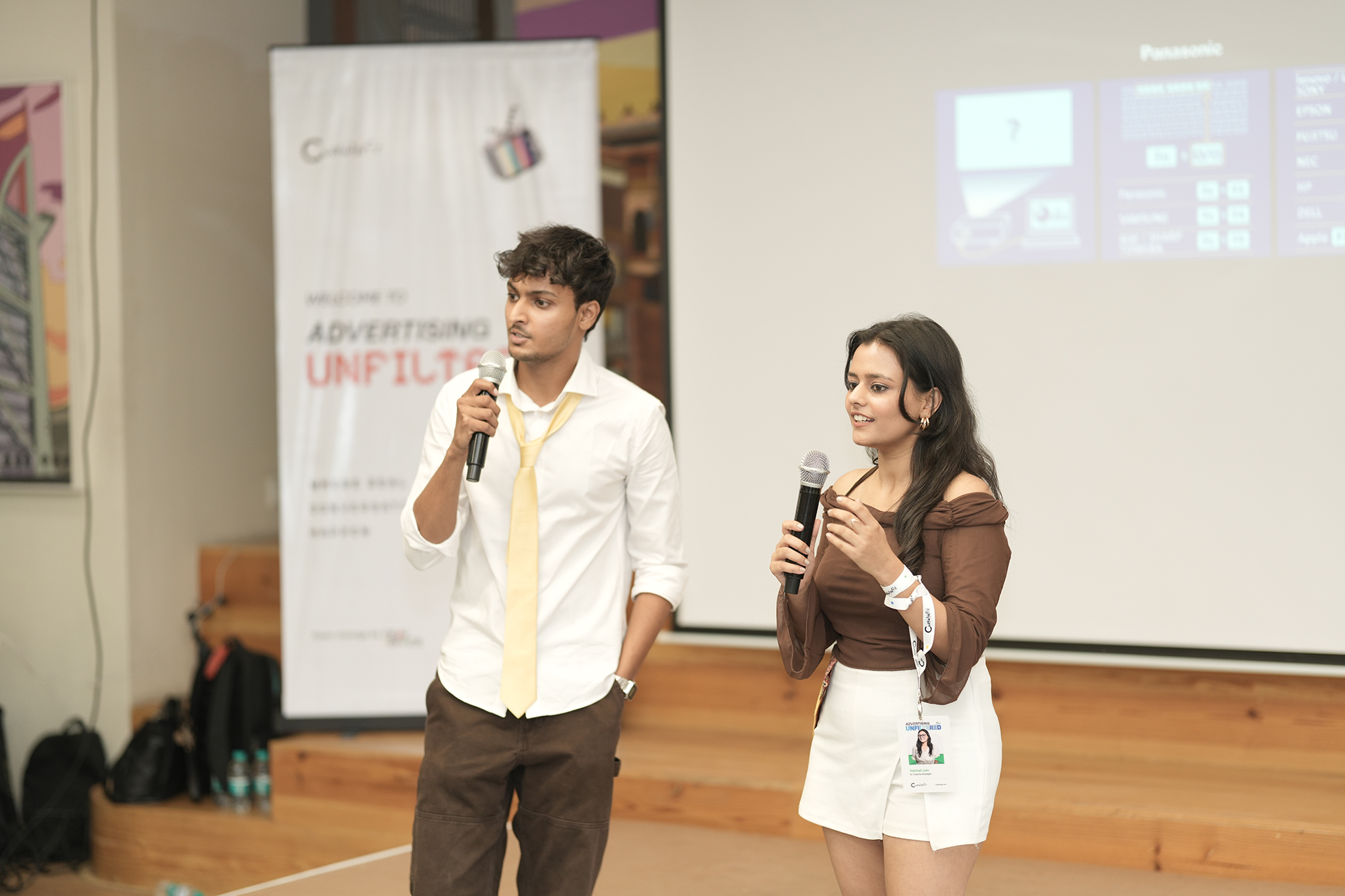 Hosts presenting on stage
